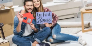 couple-showing-house-signs-young-happy-sitting-floor-our-first-text-129494166